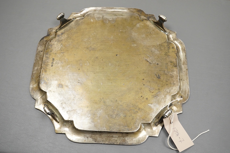 An early 20th century Indian white metal salver (tests as silver) by Hamilton & Co of Calcutta, of shaped square form, with inswept corners, on four scroll feet, 32.9cm, 38.7oz.